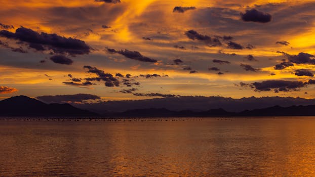 Silhouetted Mountains and a Body of Water at Sunset